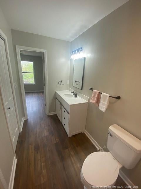 bathroom with vanity, hardwood / wood-style floors, and toilet