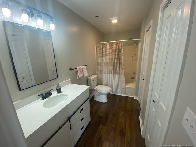 full bathroom featuring hardwood / wood-style flooring, vanity, toilet, and shower / bath combo with shower curtain