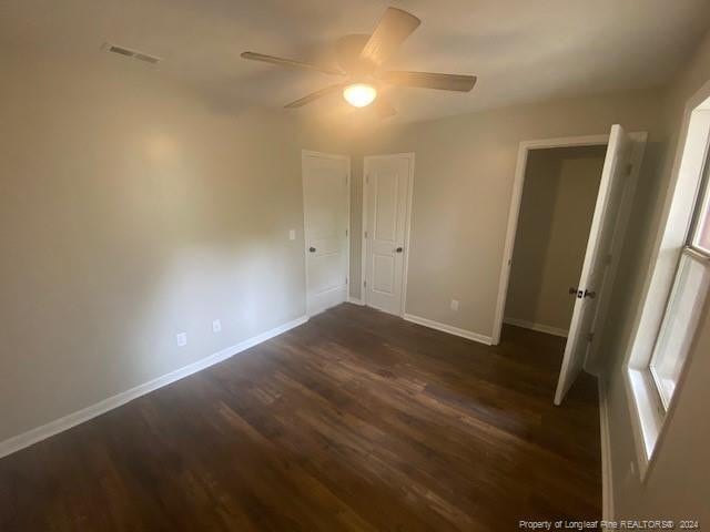 empty room featuring ceiling fan and dark hardwood / wood-style floors