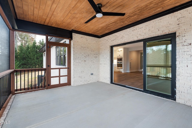 unfurnished sunroom featuring wooden ceiling and ceiling fan