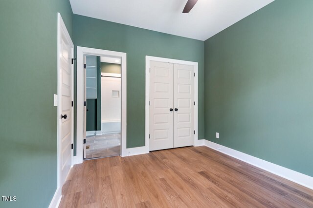 unfurnished bedroom with ceiling fan and light wood-type flooring