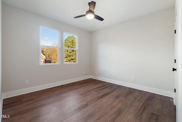 unfurnished room with ceiling fan and dark hardwood / wood-style flooring