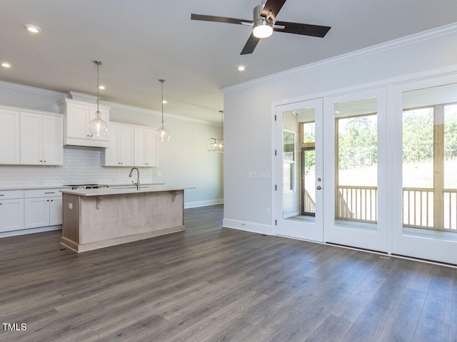 6052 Scalybark Rd, Durham, NC 27712 - kitchen with crown molding, white cabinetry, a wealth of natural light, and tasteful backsplash