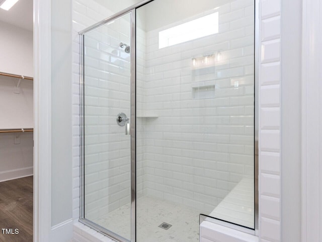 6052 Scalybark Rd, Durham, NC 27712 - full bathroom featuring a shower stall, wood finished floors, and a spacious closet