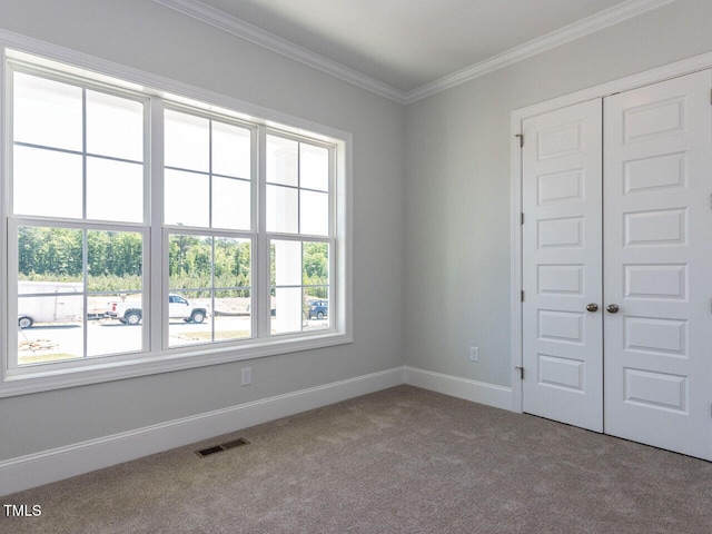 6052 Scalybark Rd, Durham, NC 27712 - carpeted spare room featuring visible vents, baseboards, and crown molding