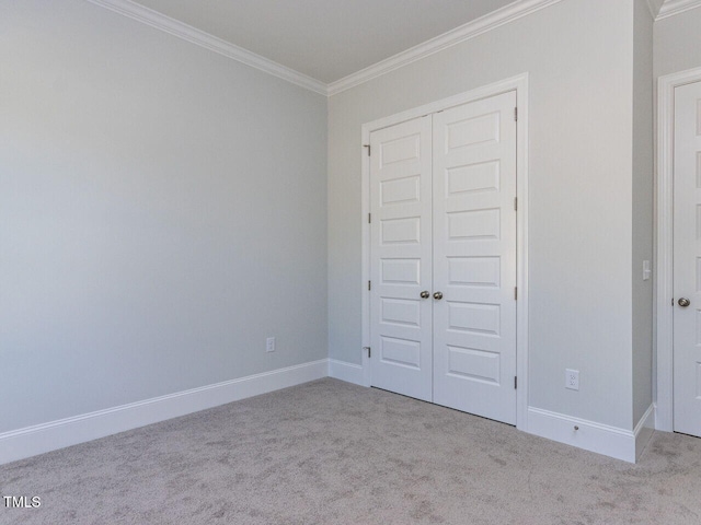 6052 Scalybark Rd, Durham, NC 27712 - unfurnished bedroom featuring carpet flooring, baseboards, ornamental molding, and a closet