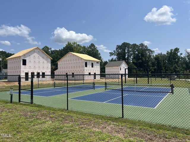 view of tennis court featuring fence