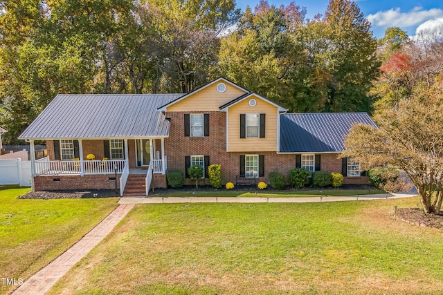 tri-level home featuring a front yard and covered porch