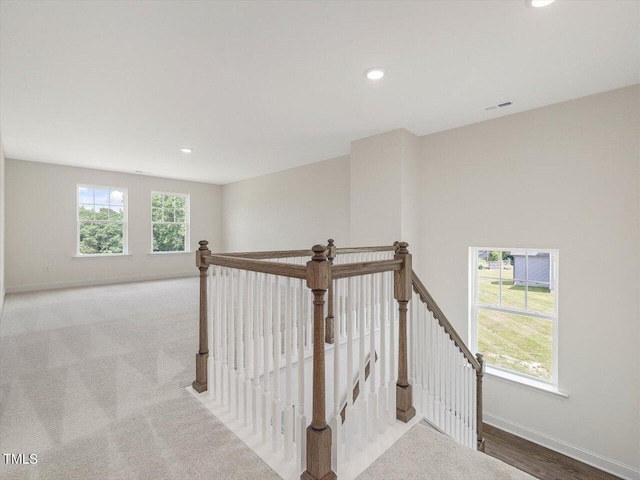 corridor with recessed lighting, baseboards, visible vents, and an upstairs landing