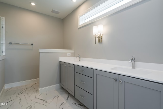 bathroom featuring recessed lighting, marble finish floor, a sink, and baseboards