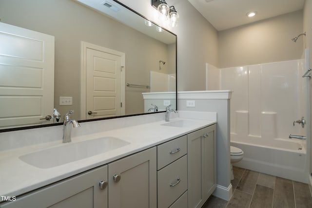 full bathroom with double vanity, visible vents, a sink, and shower / bathtub combination