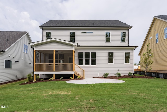 rear view of house with a sunroom, a patio, and a lawn