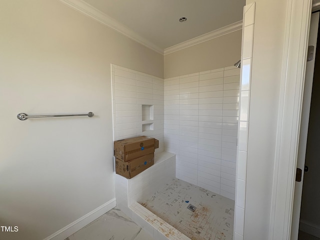 bathroom featuring marble finish floor, a shower stall, ornamental molding, and baseboards