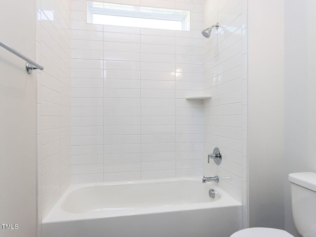bathroom featuring shower / bath combination and toilet