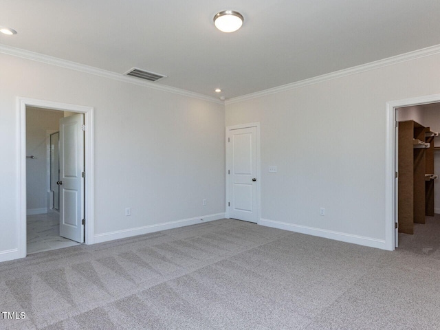 unfurnished bedroom featuring crown molding, baseboards, visible vents, and carpet floors