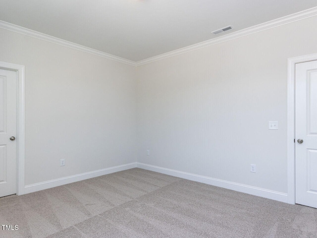 unfurnished room featuring visible vents, ornamental molding, baseboards, and light carpet