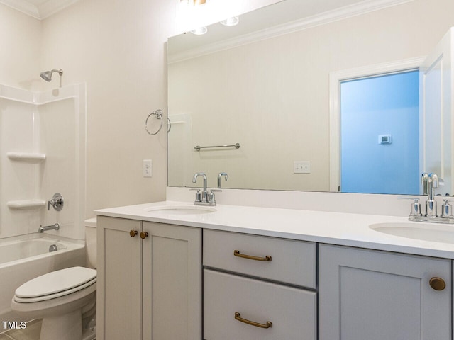 bathroom featuring double vanity, a sink, toilet, and ornamental molding
