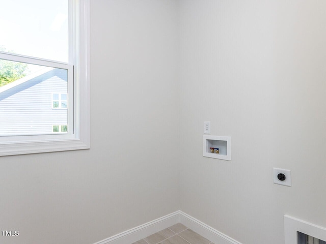 washroom featuring laundry area, baseboards, hookup for a washing machine, electric dryer hookup, and light tile patterned floors