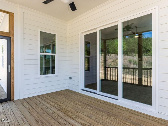 wooden terrace with a ceiling fan