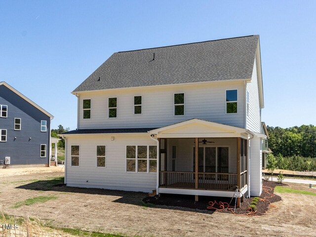 rear view of property with roof with shingles, ceiling fan, and a sunroom