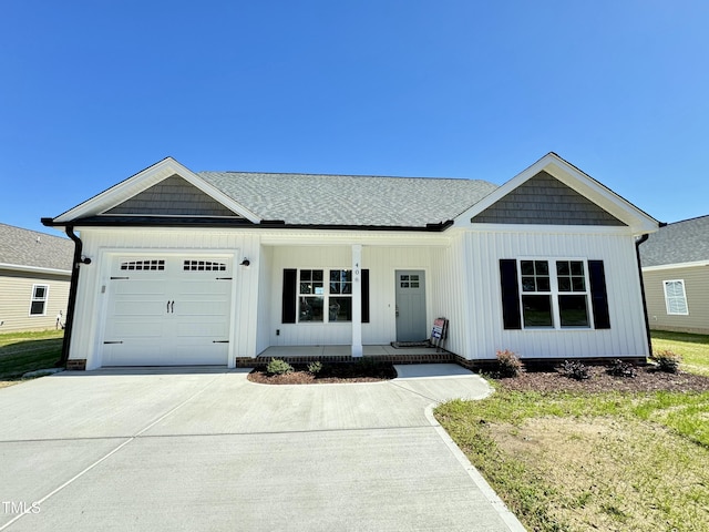 view of front of house with driveway, a porch, board and batten siding, roof with shingles, and an attached garage