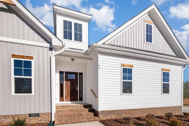 35 Uptown Rd, Zebulon, NC 27597 - entrance to property featuring board and batten siding and crawl space