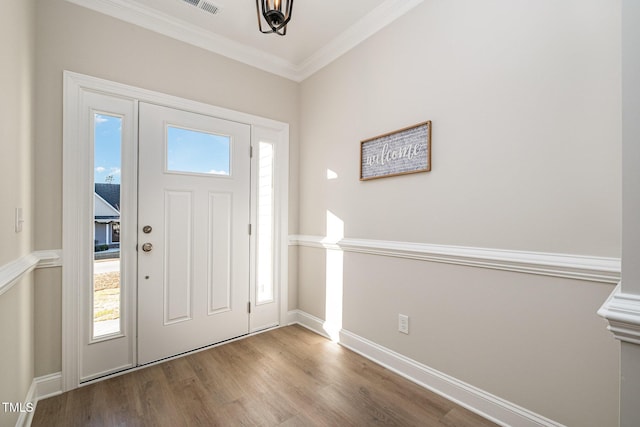 entrance foyer featuring ornamental molding and light hardwood / wood-style flooring