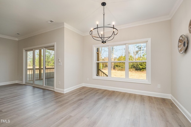 unfurnished dining area with crown molding, light hardwood / wood-style flooring, and a notable chandelier
