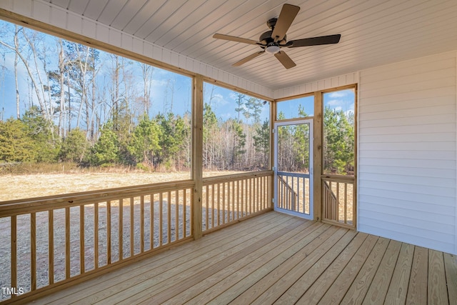 unfurnished sunroom with ceiling fan