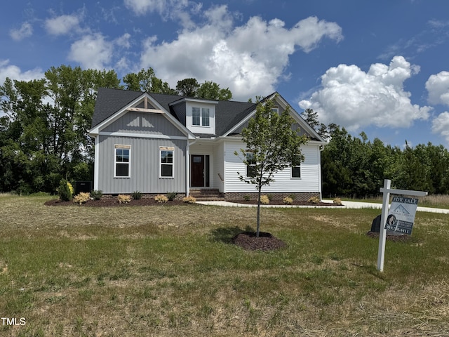 35 Uptown Rd, Zebulon, NC 27597 - view of front of property featuring a front lawn, crawl space, and board and batten siding