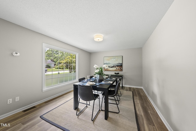 603 E Park St, Cary, NC 27511 - dining area featuring wood finished floors and a textured ceiling