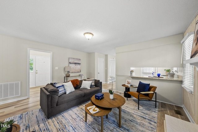 603 E Park St, Cary, NC 27511 - living area with light wood finished floors, healthy amount of natural light, and a textured ceiling
