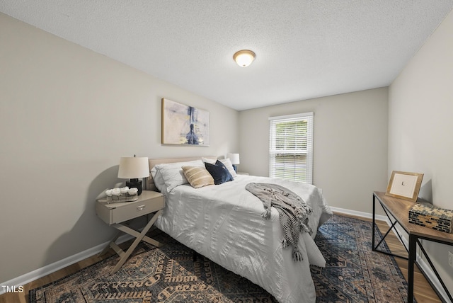 603 E Park St, Cary, NC 27511 - bedroom featuring wood finished floors and a textured ceiling