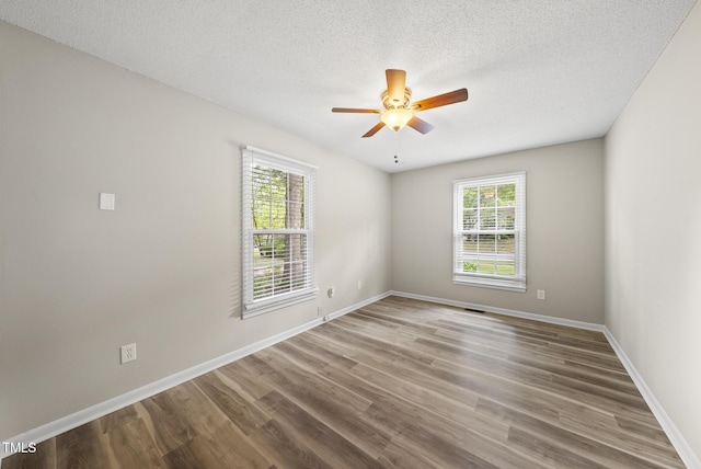 603 E Park St, Cary, NC 27511 - empty room with plenty of natural light, a ceiling fan, wood finished floors, and a textured ceiling