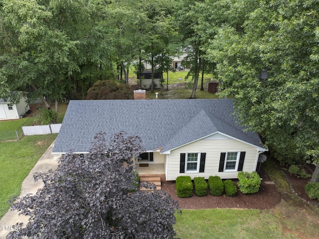 603 E Park St, Cary, NC 27511 - view of front of house featuring roof with shingles, a front yard, and a chimney