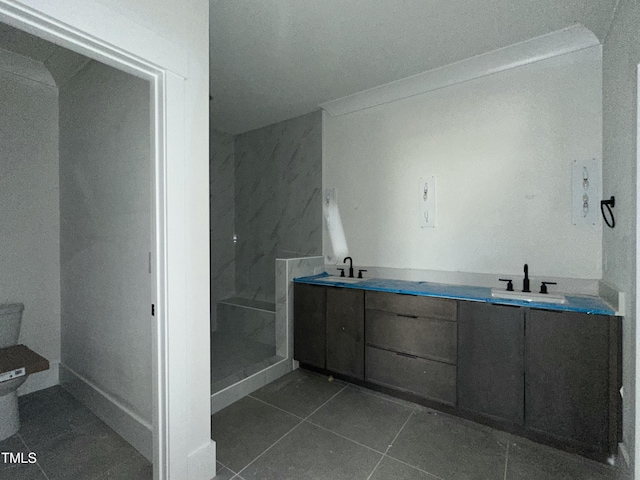 bathroom with tile patterned floors, vanity, toilet, and a shower