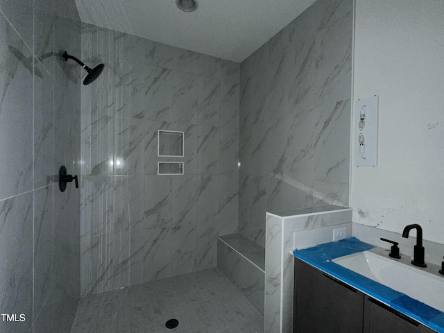 bathroom featuring vanity and a tile shower