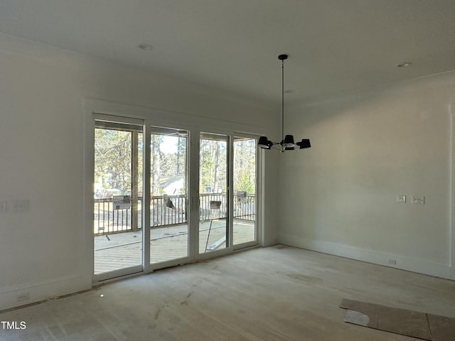 spare room featuring a chandelier