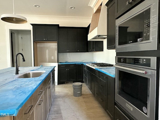 kitchen featuring sink, light stone counters, a center island with sink, custom range hood, and stainless steel appliances