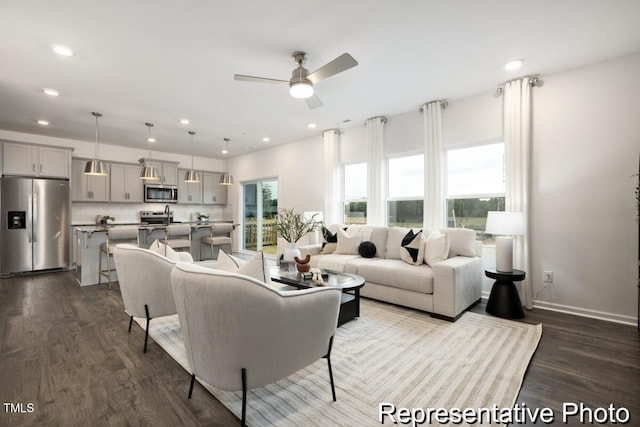 living room with dark wood-type flooring and ceiling fan