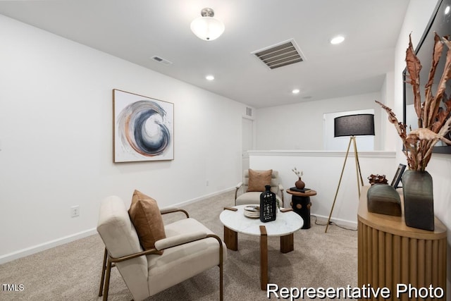 sitting room featuring light colored carpet