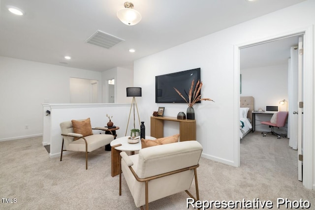 sitting room featuring light carpet