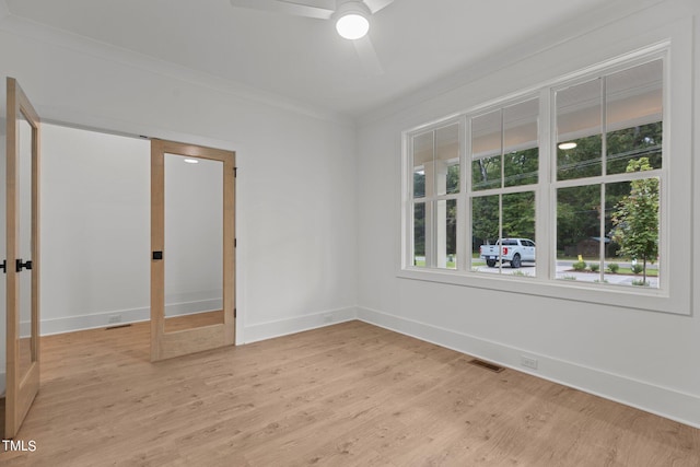 unfurnished bedroom with ornamental molding, light wood-type flooring, and ceiling fan