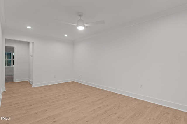 empty room featuring crown molding, light wood-style flooring, baseboards, and ceiling fan