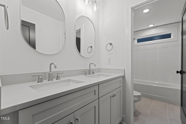 full bathroom with tub / shower combination, tile patterned floors, vanity, and toilet