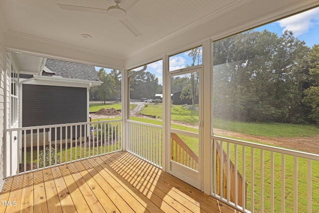 unfurnished sunroom featuring ceiling fan