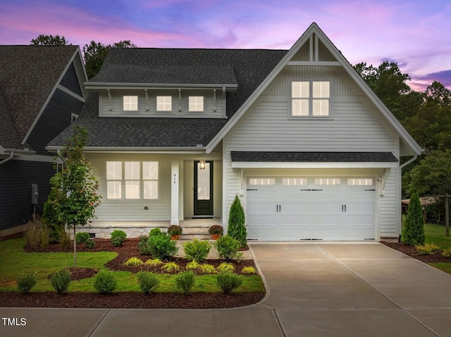 view of front of home with a garage, concrete driveway, and roof with shingles