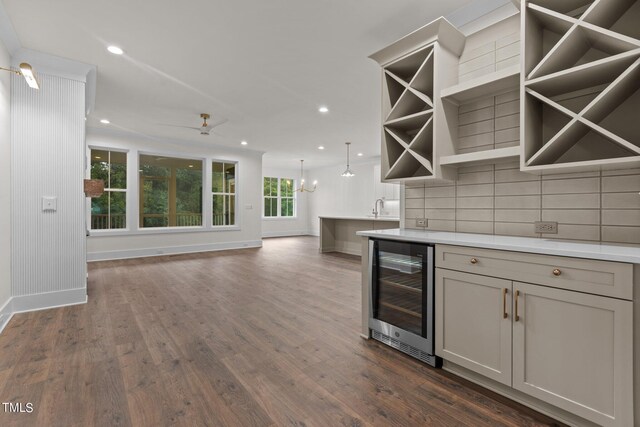 kitchen with beverage cooler, backsplash, a healthy amount of sunlight, and dark hardwood / wood-style flooring