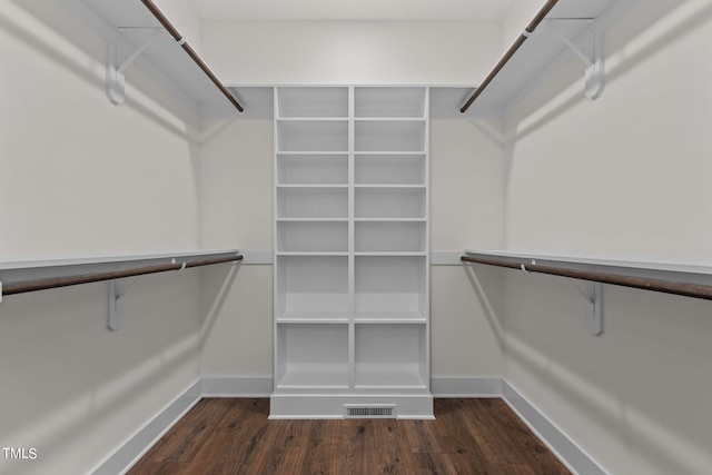 spacious closet featuring visible vents and wood finished floors