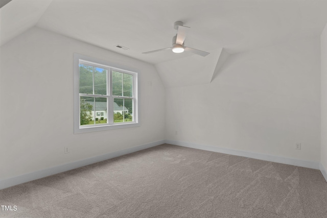 additional living space featuring lofted ceiling, baseboards, light carpet, and visible vents